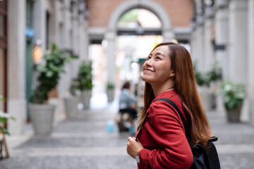 Fototapeta premium A young asian woman walking on the street while traveling and sightseeing around the city