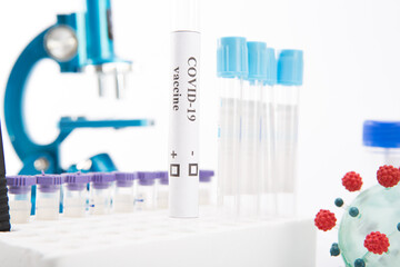 Test tube with a vaccine against coronovirus infection COVID-19 on a white background