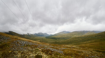 The road between the mountains on a gloomy autumn morning