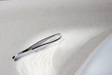 eyebrow tweezers on bathroom