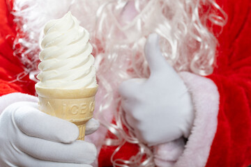 santa claus one hand holds an ice cream cone and the other hand with thumbs up