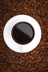 Top view of coffee cup with espresso on the many coffee beans