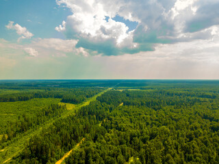 Fototapeta na wymiar Drone view of blue sky with white clouds over forest on sunny summer day. general plan