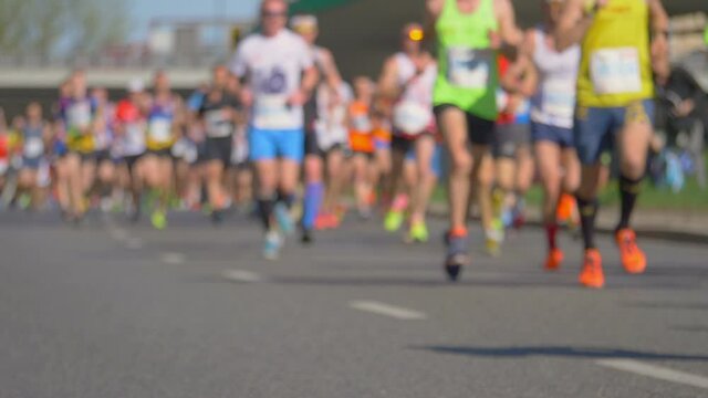 Defocused marathon runners in slow motion 180fps