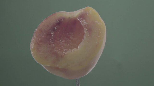 Peach rotating with loop on green screen for chroma key