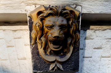 Glazed majolica lion mascaron closeup on building facade in Kyiv Ukraine