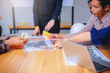 Team designer working graphic with color chart and meeting brainstorm for new project. Selected focus.