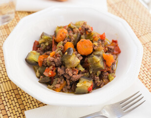 dish of vegetable stew. stewed eggplant, minced meat, carrots, peppers, onion squid