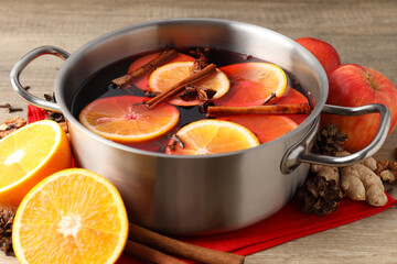 Concept of cooking  mulled wine on wooden background