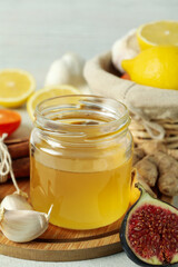 Concept of treatment colds with honey and garlic, close up