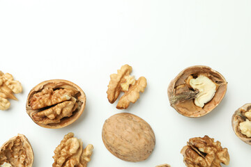 Walnuts with nutshell on white background, top view