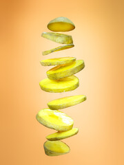 Slices of potato floating on orange background