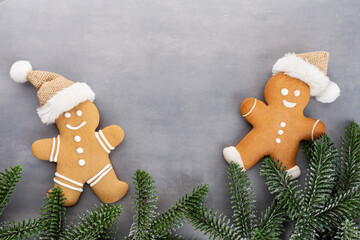 Gingerbread man, cookies and Christmas decor on pastel background.