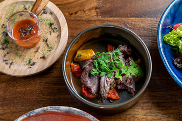 Elegant and delicious food on restaurant. Plate with tasty meal on the wooden table. Gourmet cuisine, lunch, dinner, beautiful, modern