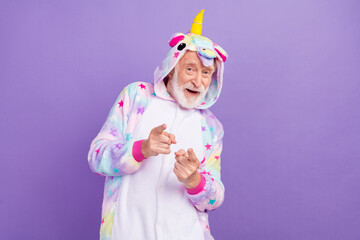 Portrait of attractive cheerful grey-haired man dancing moving pointing at you isolated over violet purple color background