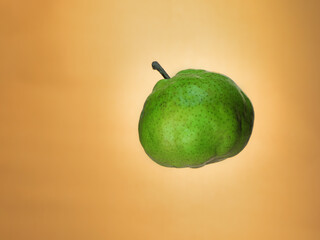 Levitating pear on orange background