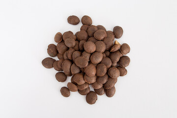 Sacha Inchi roasted seed nuts, selective focus on front seeds, on white background
