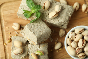 Concept of tasty food with halva on wooden background