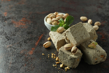 Concept of tasty food with halva on dark textured background