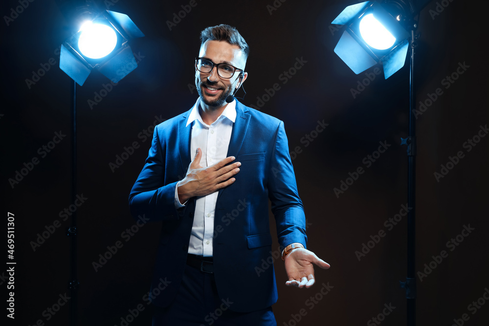 Wall mural motivational speaker with headset performing on stage
