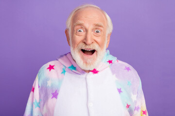 Photo of funny impressed man pensioner unicorn sleepwear open mouth smiling isolated violet color background