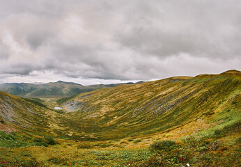 Valley between the mountains on an autumn cloudy day