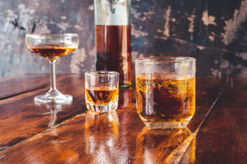  Liquor  glass and liquor bottles on wooden table