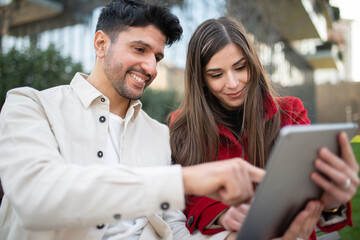 Couple using a tablet outdoors