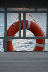 The red lifebuoy against the nice wave background giving the sense of safety, calmness and serenity