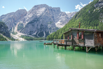 Lake Braies (also known as Pragser Wildsee or Lago di Braies) in Dolomites Mountains, Sudtirol, Italy. Romantic place with typical wooden boats on the alpine lake. Hiking travel and adventure.