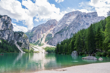 Fototapeta na wymiar Lake Braies (also known as Pragser Wildsee or Lago di Braies) in Dolomites Mountains, Sudtirol, Italy. Romantic place with typical wooden boats on the alpine lake. Hiking travel and adventure.