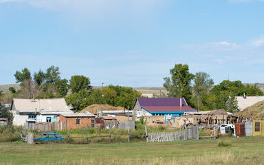 A colorful village with small, vibrant houses, encapsulating the charm of rural settlements in eastern Kazakhstan.
