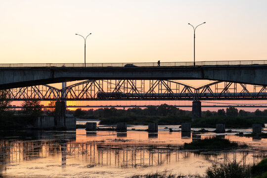 The iron bridge spanning the Irtysh River at sunset in Semey, Kazakhstan, highlighting the industrial heritage of the region