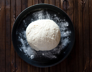 Process of raising the dough in a special basket. Dough made from natural sourdough. Wheat dough. Fermentation. Top view.	