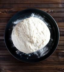 Process of raising the dough in a special basket. Dough made from natural sourdough. Wheat dough. Fermentation. Top view.	
