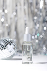 Bottles of cosmetics for skin care on a New Year's background. New Year and Christmas a woman presents an idea 