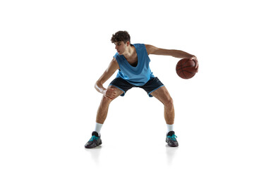 Obraz na płótnie Canvas Dynamic portrait of basketball player practicing isolated on white studio background. Sport, motion, activity, movement concepts.
