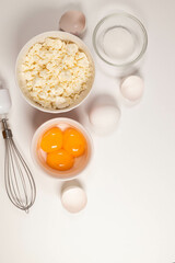 Ingredients for winter festive baking - flour, sugar, eggs, butter on white background. Top view. Flat lay.