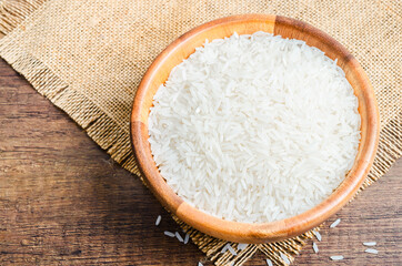 Organic Thai Jasmine rice grain in wooden bowl preparing.