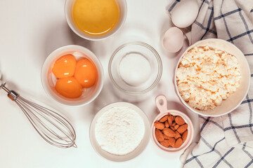 Fototapeta na wymiar Baking utensils and cooking ingredients for a tarts, cookies, dough and pastry. Flat lay with eggs, flour, sugar, cottage cheese