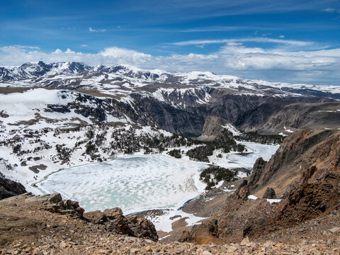 Snow-capped mountains and a frozen lake near Beartooth Pass