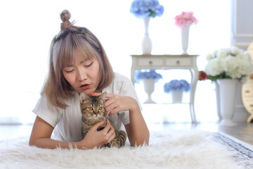 young woman and cat in apartment living room