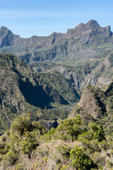 Fototapeta premium Scenic Mountain Landscape. A sweeping view of La Réunion’s mountainous landscape, with deep valleys and green slopes under the tropical sun.