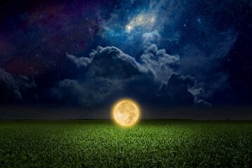 Unreal fantastic image - luminous sphere, similar to full moon, levitates over green field. Bright...