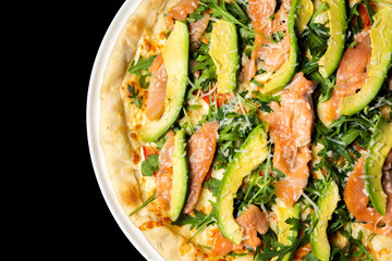 Delicious pizza close up, white plate on black background