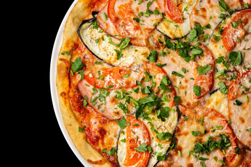 Delicious pizza close up, white plate on black background