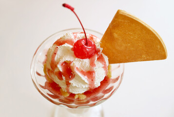 Closeup of Maraschino Cherry Topped on Strawberry Ice Cream Sundae Whipped Cream