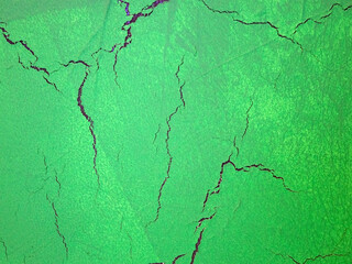 Cracks on a green background. The green texture of cracked wood.