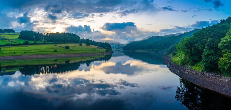 View of dramatic clouds reflecting in Ladybower Reservoir at sunset, Peak District National Park, Derbyshire