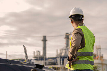 Fototapeta premium Asian man petrochemical engineer working at oil and gas refinery plant industry factory,The people worker man engineer work control at power plant energy industry manufacturing